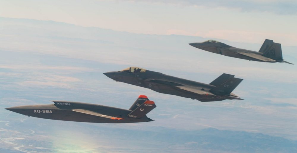 XQ-58A Valkyrie, F-35 Lightning II, and F-22 Raptor fly in formation